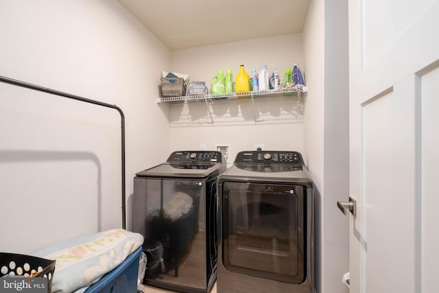 laundry room featuring separate washer and dryer and hardwood / wood-style flooring