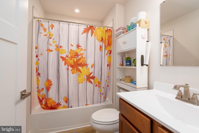 full bathroom featuring hardwood / wood-style floors, vanity, toilet, and shower / tub combo with curtain