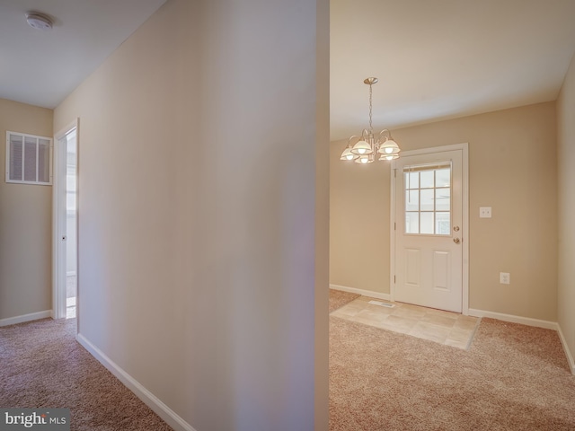 interior space featuring light colored carpet and a notable chandelier