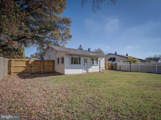 back of property featuring a lawn