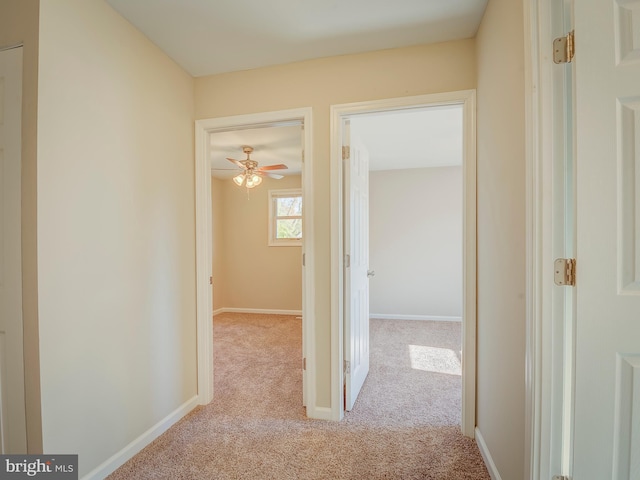 hall featuring light colored carpet