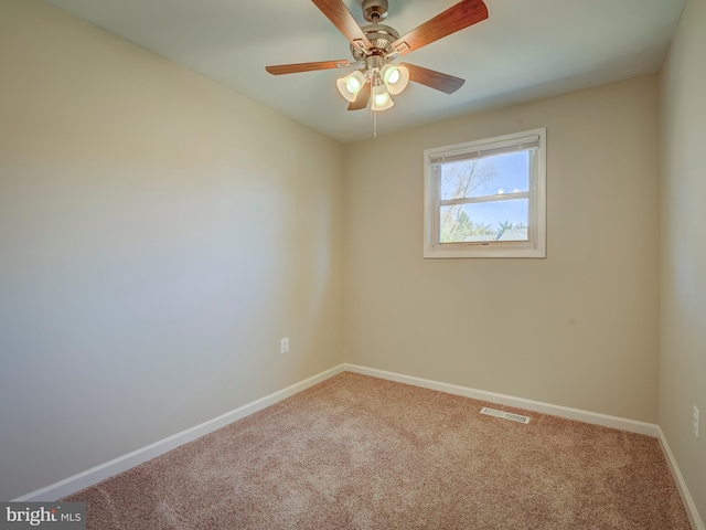 unfurnished room featuring ceiling fan and carpet floors