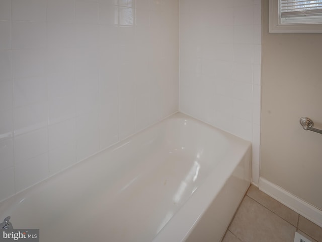 bathroom featuring a washtub and tile patterned floors