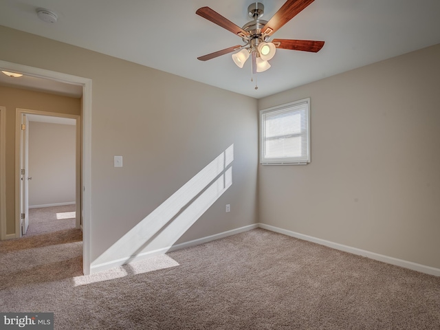 spare room with light colored carpet and ceiling fan