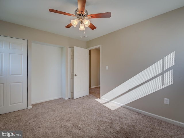 unfurnished bedroom featuring light carpet and ceiling fan