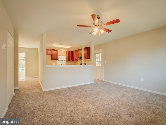 unfurnished living room with light carpet and ceiling fan