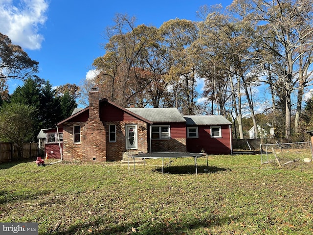 94 Pine Rd, Pasadena, MD 21122 - view of front of property featuring a trampoline, a chimney, and brick siding