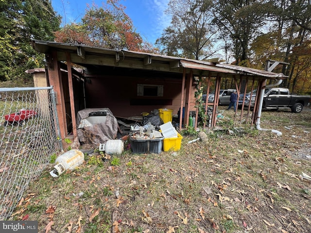 94 Pine Rd, Pasadena, MD 21122 - view of outdoor structure featuring a carport and fence
