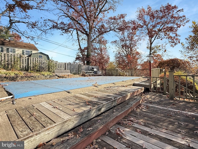 wooden deck with a covered pool