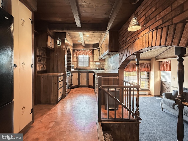 interior space featuring tile patterned floors, beam ceiling, wooden walls, sink, and wooden ceiling