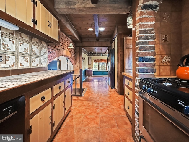 kitchen featuring dishwasher, white cabinets, stainless steel range with gas stovetop, wooden ceiling, and beam ceiling