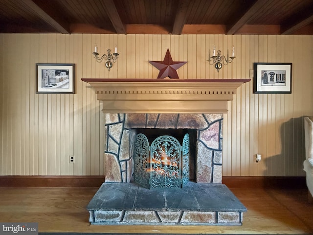 room details featuring a stone fireplace and wooden walls