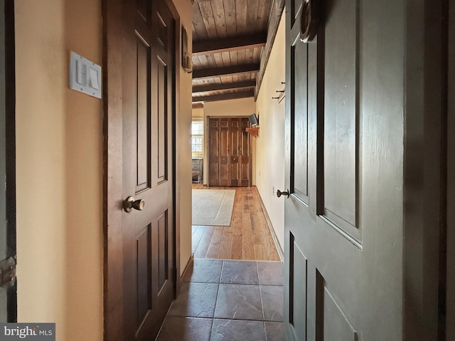 hall featuring wood ceiling, vaulted ceiling with beams, and dark hardwood / wood-style floors