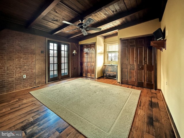 interior space with hardwood / wood-style floors, a wealth of natural light, and beamed ceiling