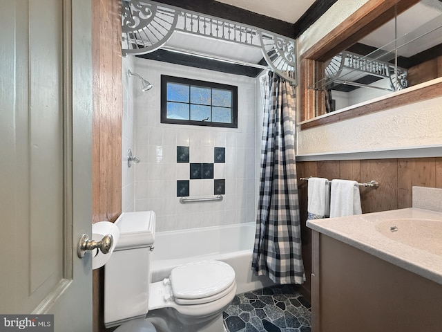 full bathroom with shower / bath combo, vanity, wooden walls, and toilet