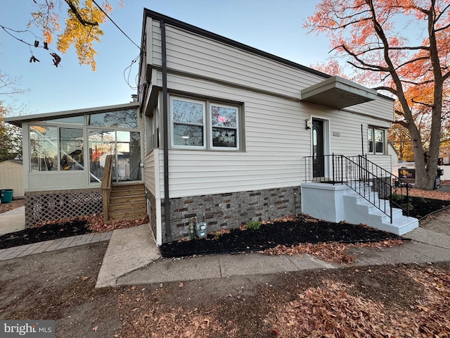 view of front of house with a sunroom