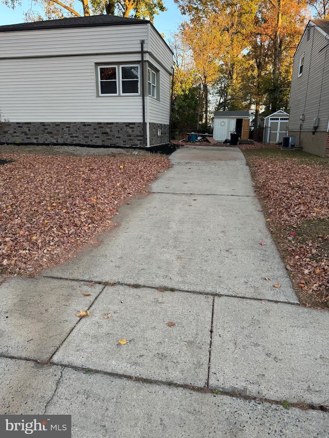 view of home's exterior featuring a storage unit and central air condition unit