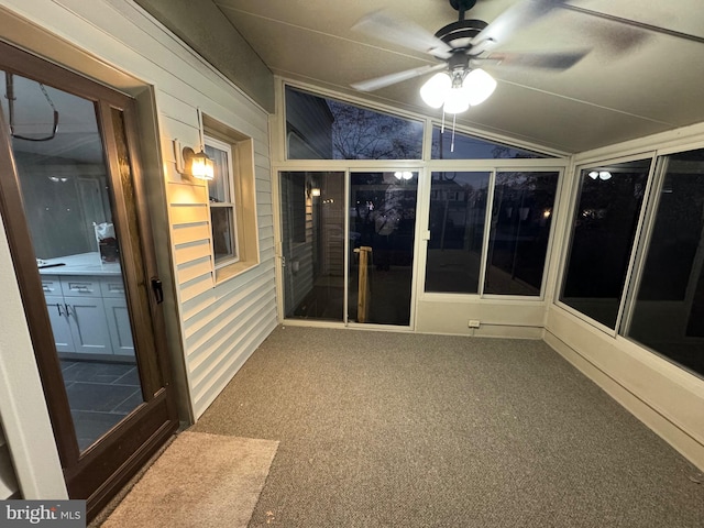 unfurnished sunroom featuring ceiling fan and lofted ceiling