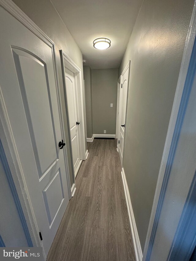 corridor featuring dark hardwood / wood-style floors