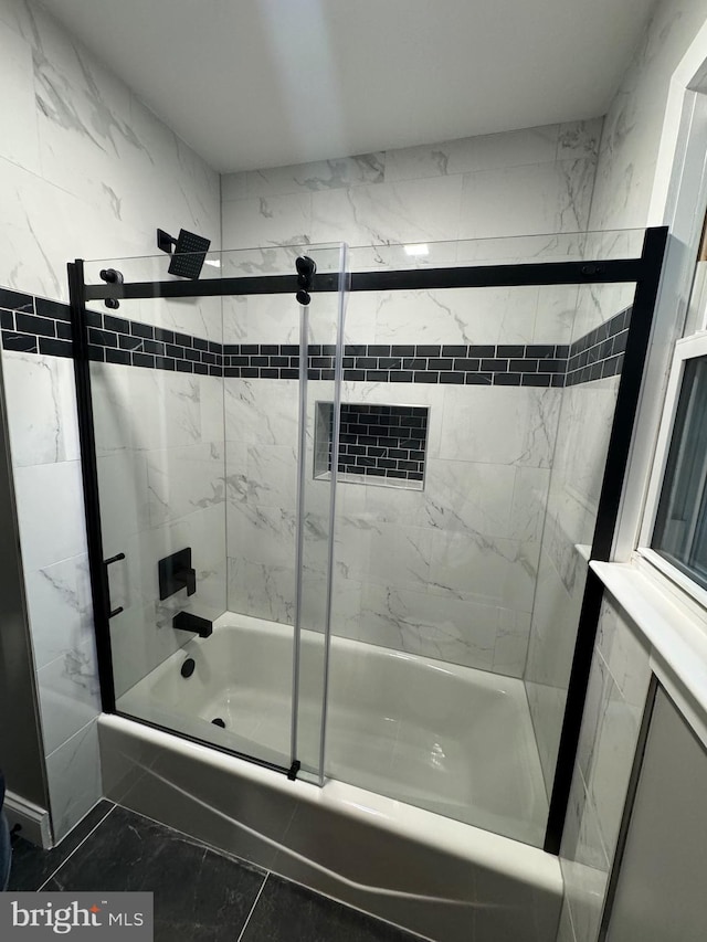 bathroom featuring bath / shower combo with glass door