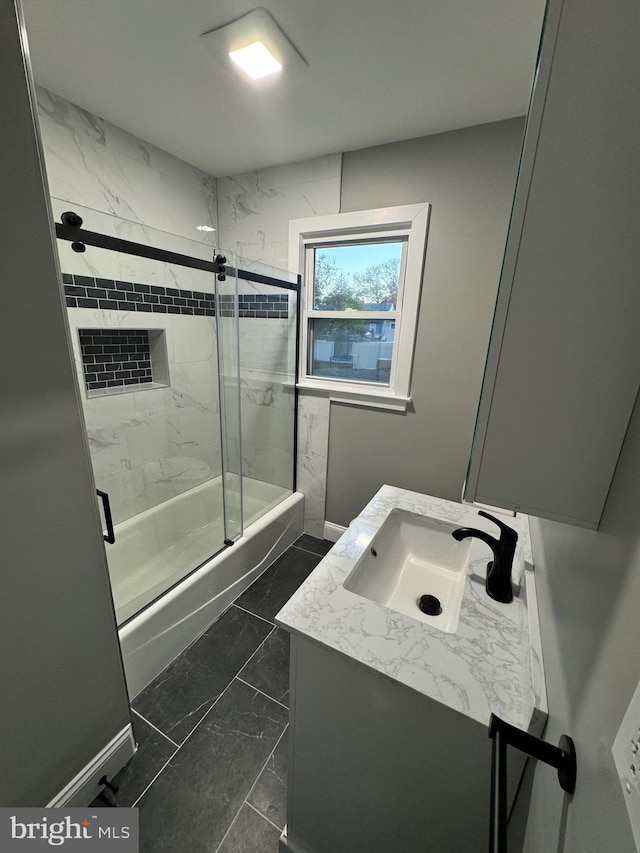 bathroom featuring vanity and enclosed tub / shower combo