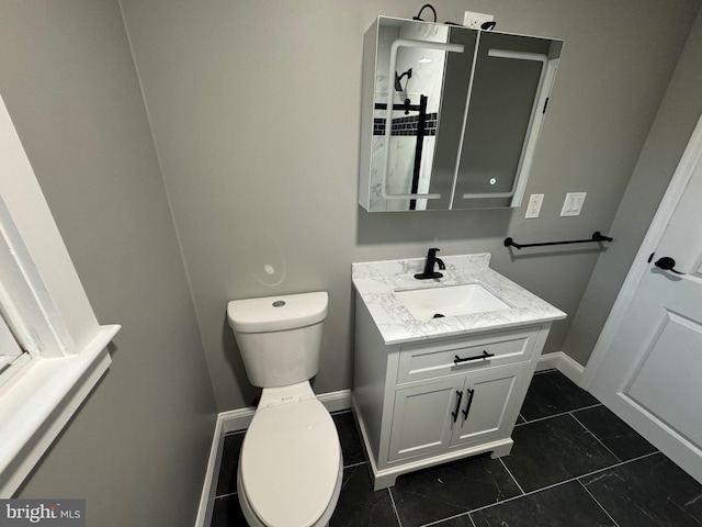 bathroom with tile patterned flooring, vanity, and toilet