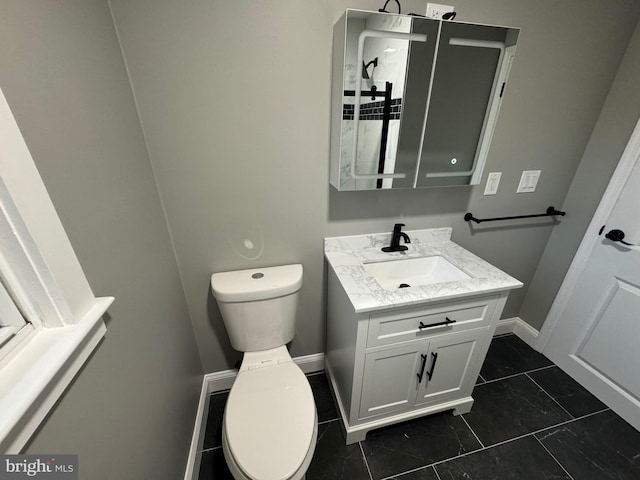 bathroom featuring tile patterned floors, vanity, and toilet