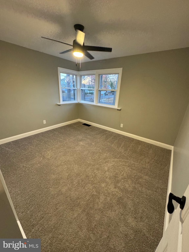 empty room with carpet, a textured ceiling, and ceiling fan