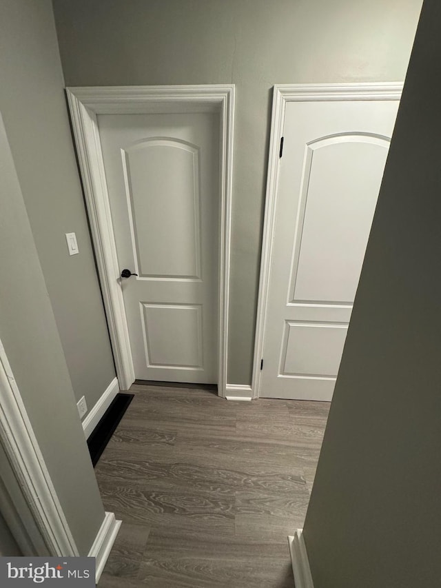 hallway with dark hardwood / wood-style floors