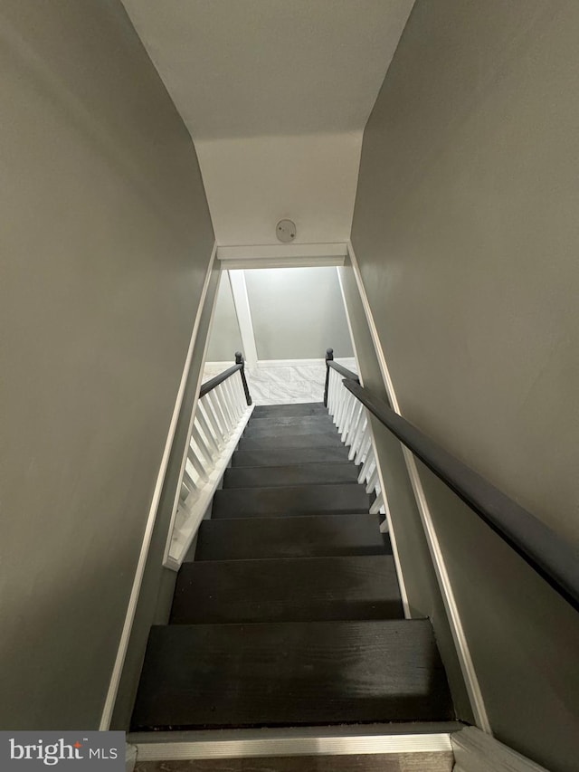 stairway with vaulted ceiling