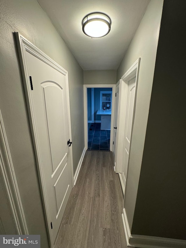 hallway with dark wood-type flooring