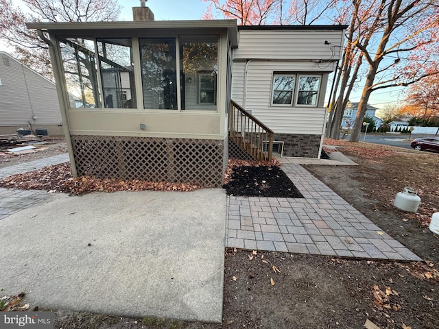 exterior space featuring a sunroom