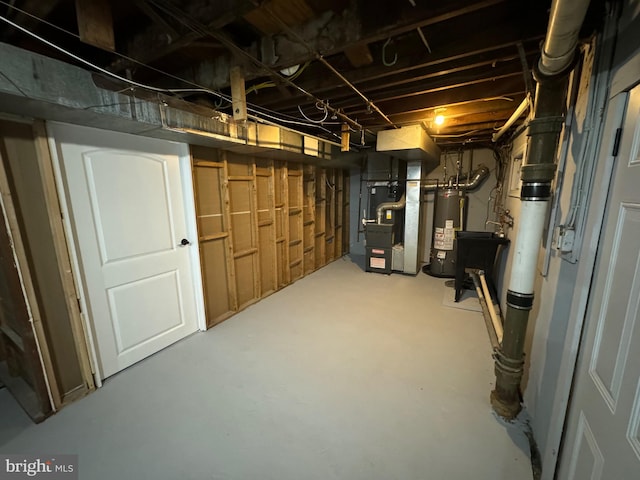 basement with gas water heater and heating unit