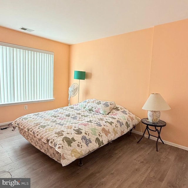 bedroom with wood-type flooring