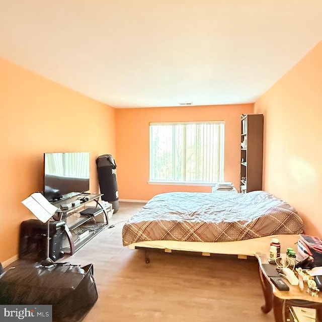 bedroom with hardwood / wood-style flooring