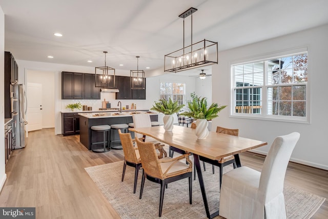 dining room featuring recessed lighting, light wood-style floors, a ceiling fan, a chandelier, and baseboards