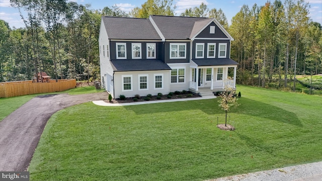 view of front facade featuring covered porch and a front yard