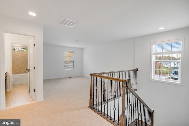 hallway featuring an upstairs landing, carpet flooring, recessed lighting, and baseboards