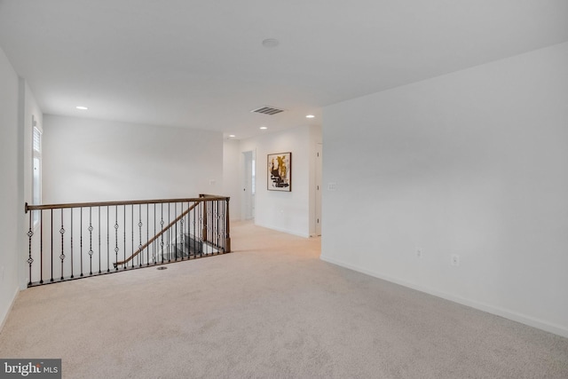unfurnished room with carpet floors, recessed lighting, and baseboards