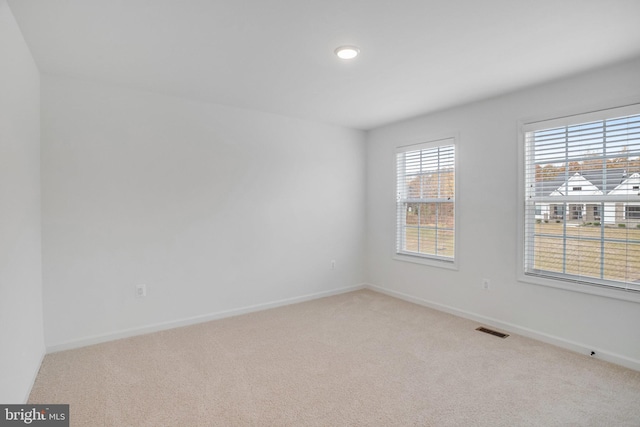 unfurnished room with light carpet, baseboards, and recessed lighting