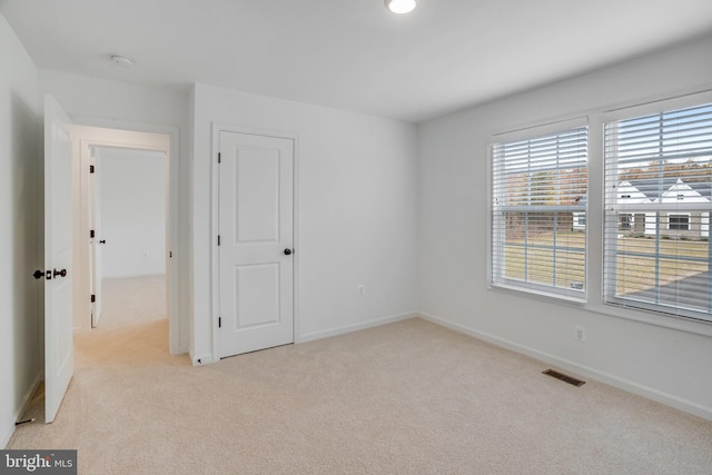 spare room with light colored carpet