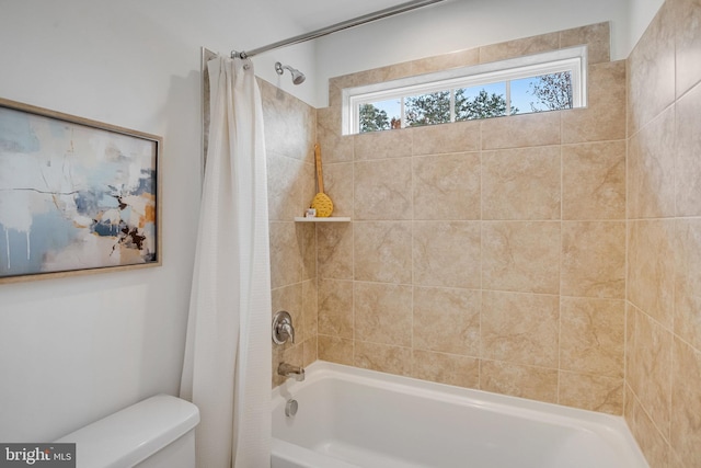 full bathroom featuring toilet and shower / bathtub combination with curtain