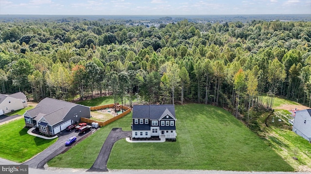 view of subject property with a heavily wooded area