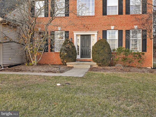 view of exterior entry with a yard