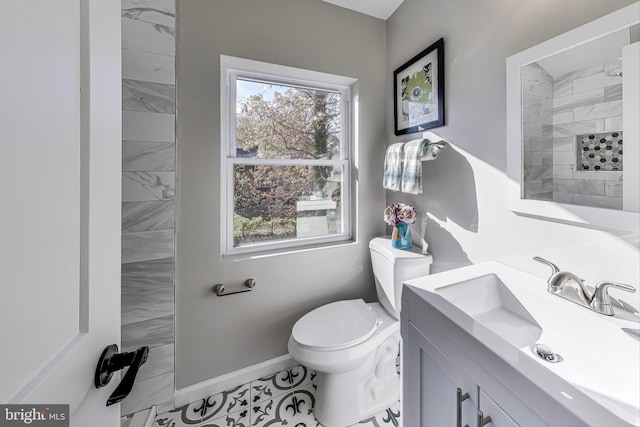 bathroom with vanity, tile patterned floors, and toilet