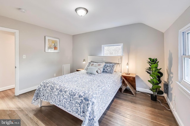 bedroom with hardwood / wood-style flooring and lofted ceiling