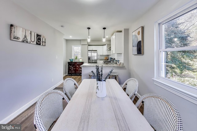 dining room featuring dark wood-type flooring and sink