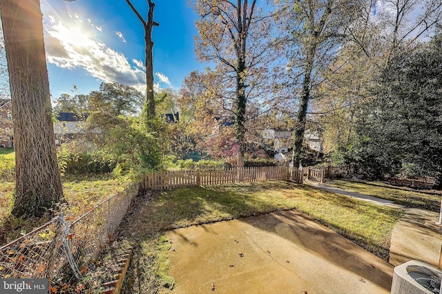 view of yard with central AC unit and a patio area