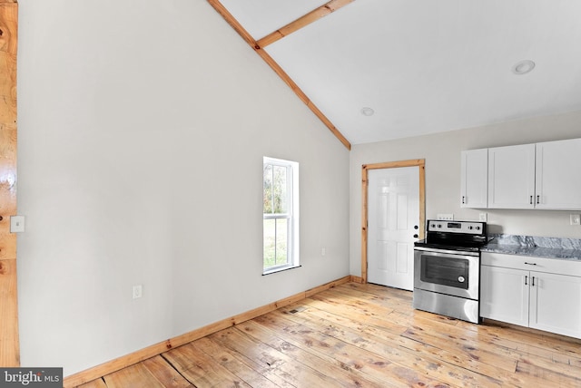 kitchen with light hardwood / wood-style flooring, high vaulted ceiling, stainless steel range with electric cooktop, dark stone counters, and white cabinets