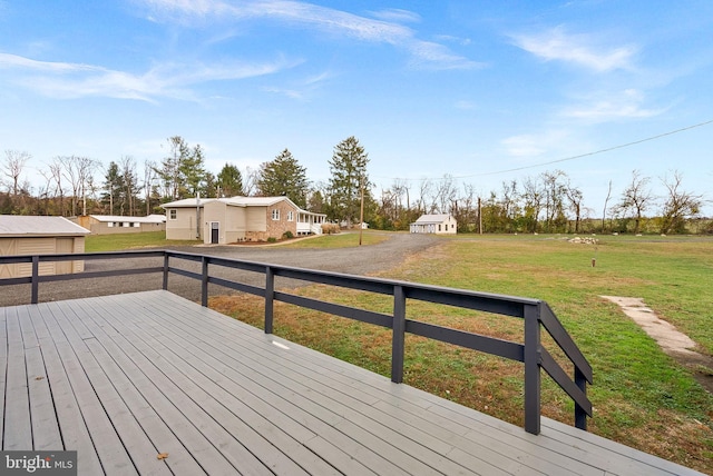 wooden deck featuring a lawn